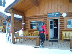 Skier arriving at Shadow Lake Lodge amid a few snow flurries