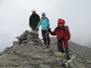 Ray, Mary and Keith on the pinnacle of Windtower mountain. It was windy and cool, and we were being pelted with sleet when taking this photo