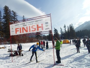 A skier crosses the finish line in the Lake Louise to Banff loppet in 2013
